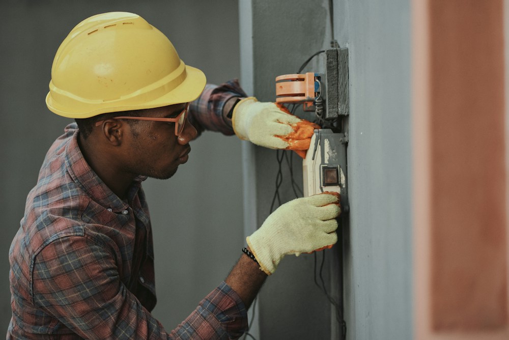 An electrician carefully completing an electrical installation